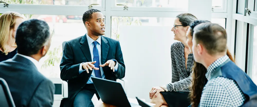 Group of people in suits talking together