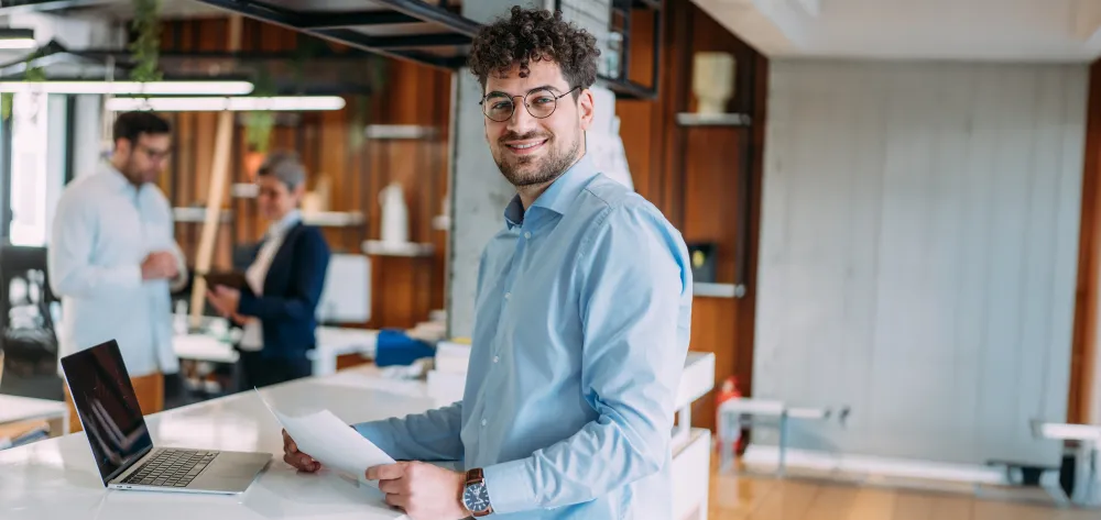 Young male profressional smiling while in the office