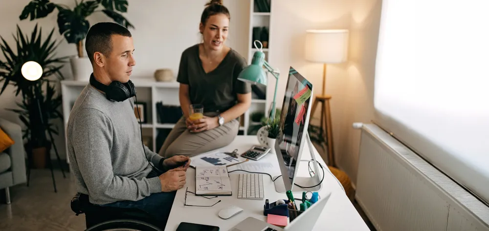 Man with special needs sitting at his desk working