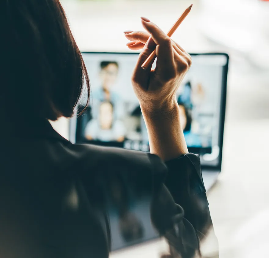 Woman sitting at her desk on a virtual meeting