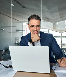 Business professional male in a suit working at his computer