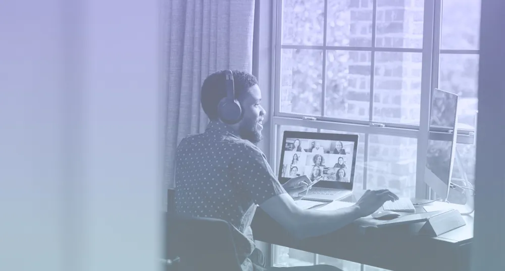 Young professional on a virtual meeting at his desk