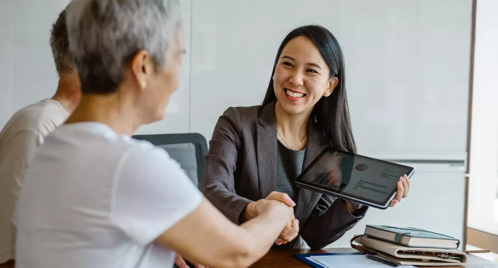 Female retirement advisor meeting with her clients