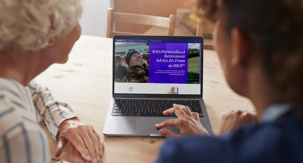 Young man showing older women how to use her laptop