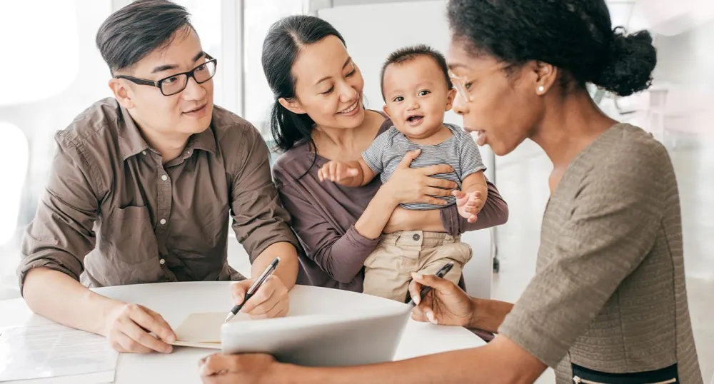 Young family meeting with their female financial advisor