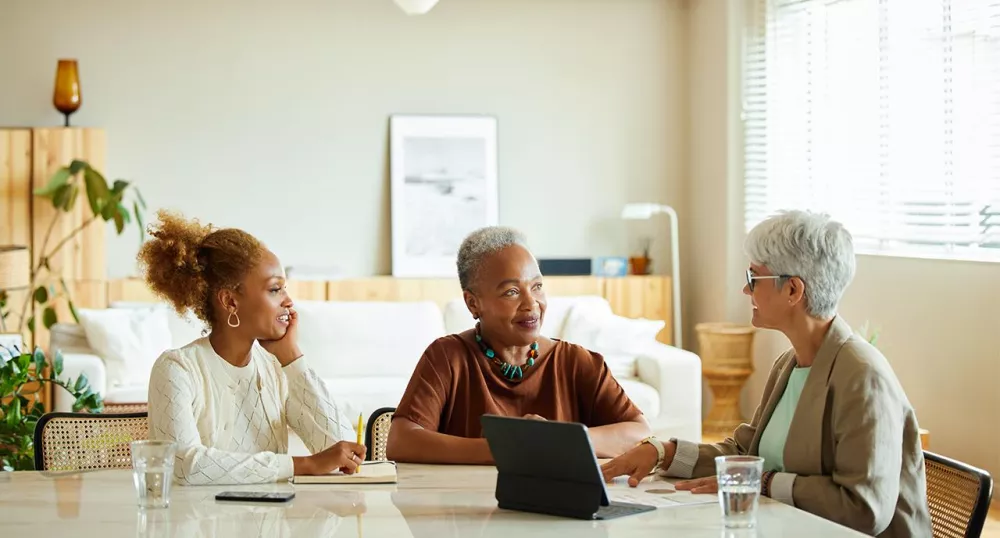 An eldery woman and her daughter meeting with a retirement advisor