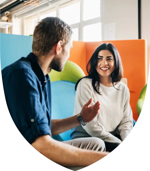 Professional man and woman speaking in the office