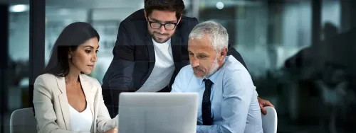 Group of coworkers gathered around the computer