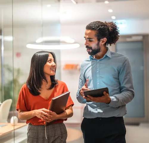 Male and female coworkers in the office together