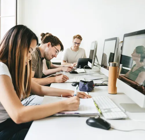 Group of coworkers in the office at their desks