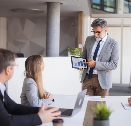 Middle aged man presenting to his clients on a tablet