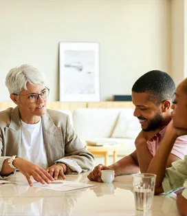 Experienced female advisor meeting with a couple at the table