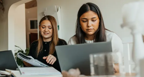 Two Gen Z females studying at their desk