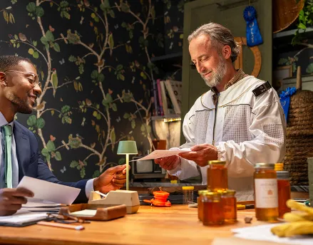 Beekeeper and his financial advisor talking at the table