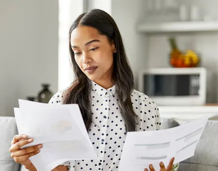 Young female professional reading various reports