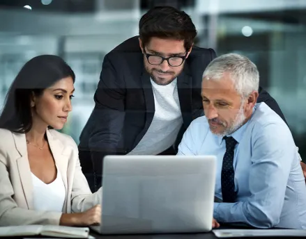 Group of coworkers gathered around the computer