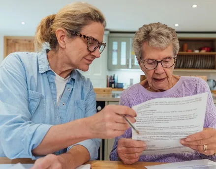 Daughter helping her mother with retirement paperwork