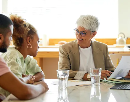 Senior financial advisor helping a young married couple