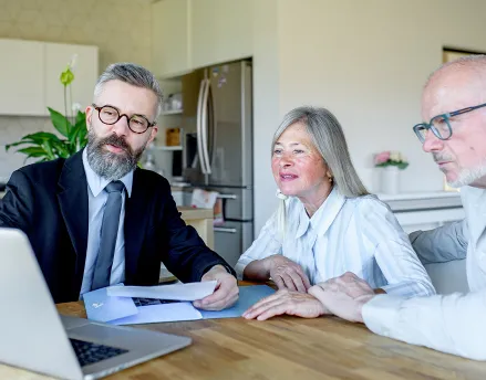 Middle aged advisor meeting with retiree couple