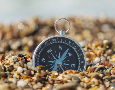 Compass sitting in a bed of rocks