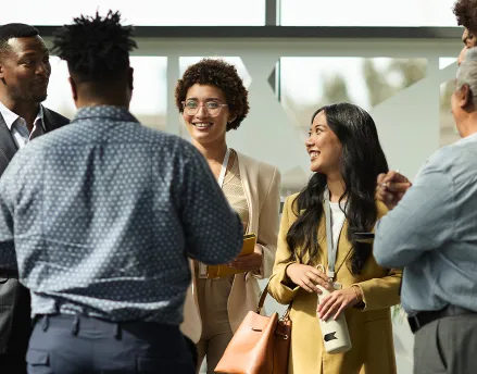 Diverse group of young professional standing in a circle talking