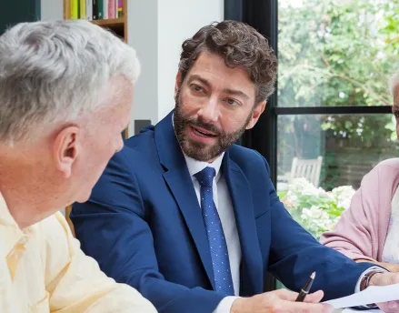 Financial advisor meeting with two elderly clients