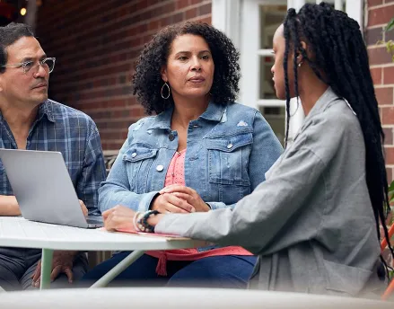 Parents talking with their daughter at the table
