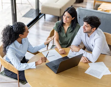 Female financial advisor meeting with a married couple