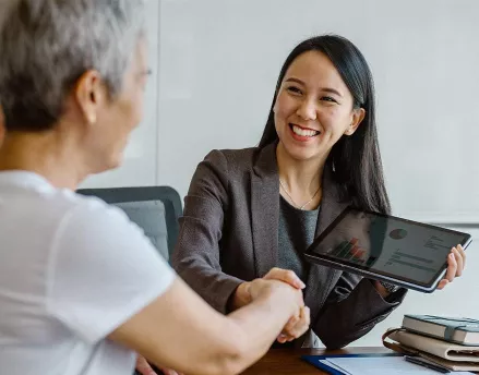 Female retirement advisor meeting with her clients