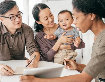 Young family meeting with their female financial advisor