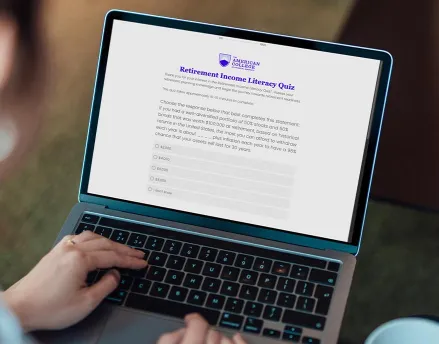 Woman looking at the Retirement Income Literacy Study on her laptop