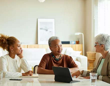 An eldery woman and her daughter meeting with a retirement advisor