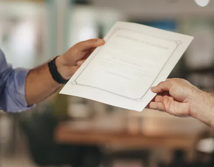 Man being handed his proof of certification
